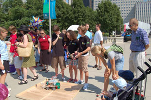 Winning members of the South Middle School Science Olympiad team from Arlington Heights, Illinois, demonstrate their Robo-Cross device at the Science Chicago kick-off press announcement in Millennium Park on July 29, 2008.